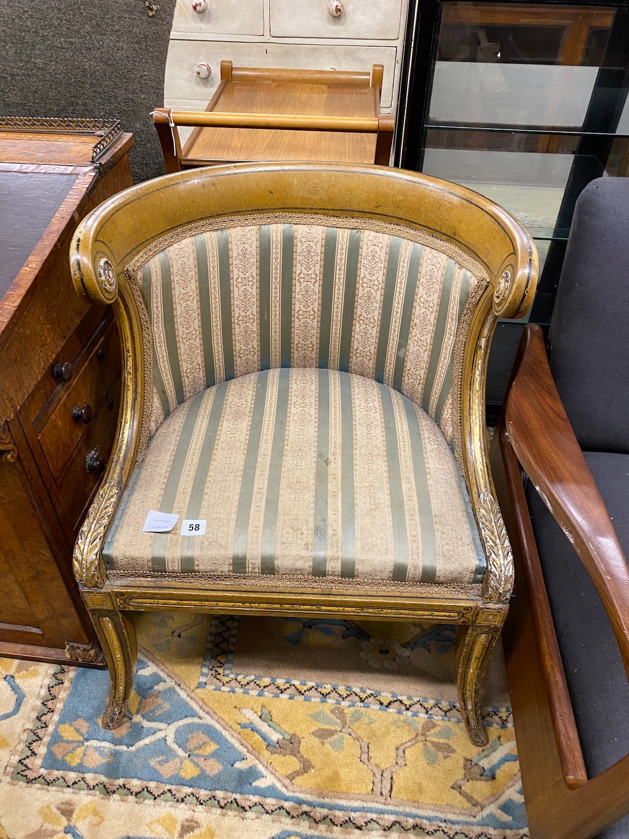 A Regency painted, parcel gilt upholstered side chair with scroll back and acanthus mounts over swept legs, width 56cm, depth 45cm, height 73cm